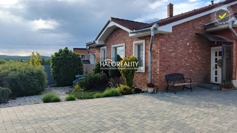 A family house in Kalinovo with a brick facade and a landscaped garden.