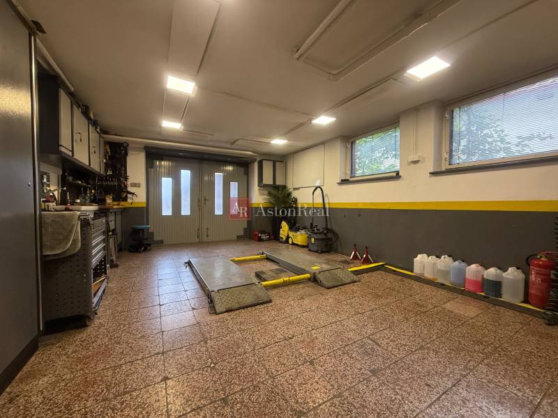 Garage in a family house with equipment, tools, and storage spaces.