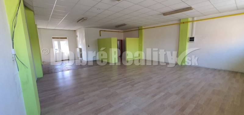 Spacious commercial spaces with a bright interior and green accents.