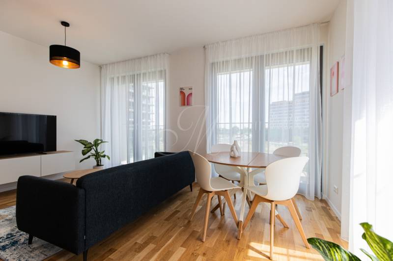 Living room in a 3-room apartment with a sofa, television, and dining table.