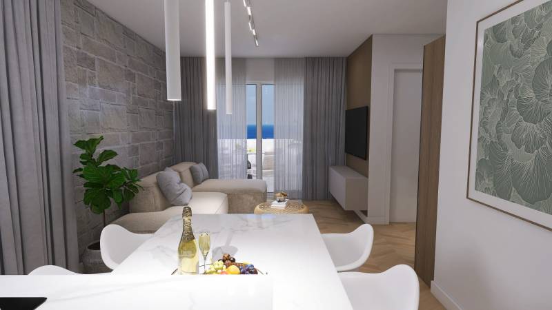 Living room in a 4-room apartment with a stone wall, sofa, and sea view.