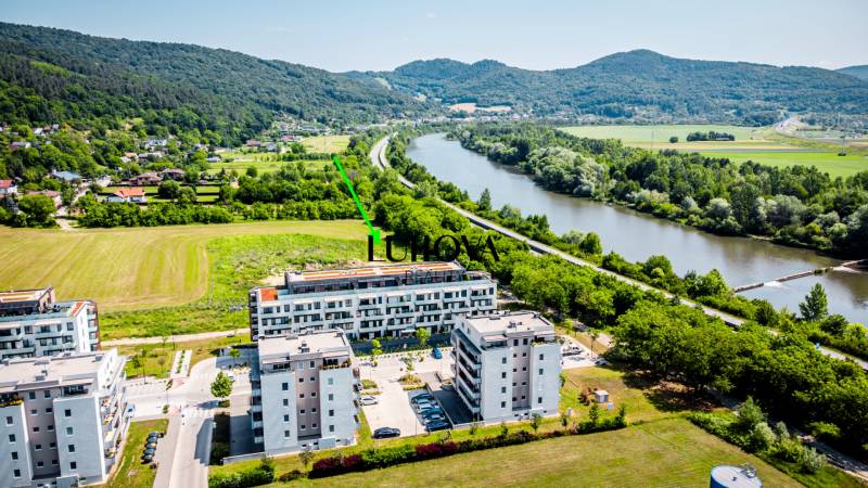 Aerial view of residential buildings on Dlhé lúky street in Púchov, surrounded by greenery.
