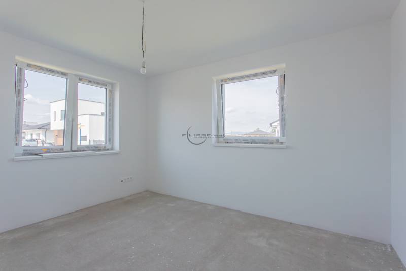 Empty room with white walls and windows, construction in a family house.