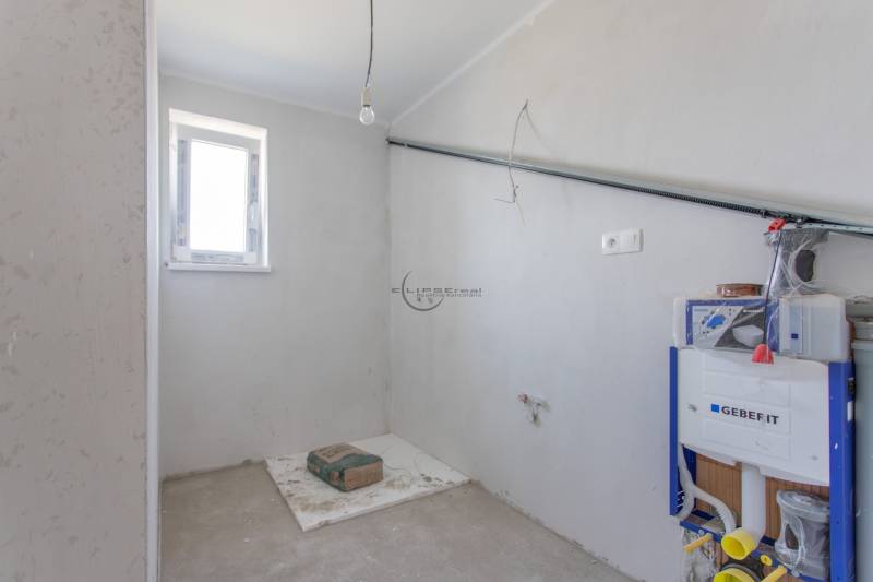 A partially finished bathroom in a family house with installation elements.
