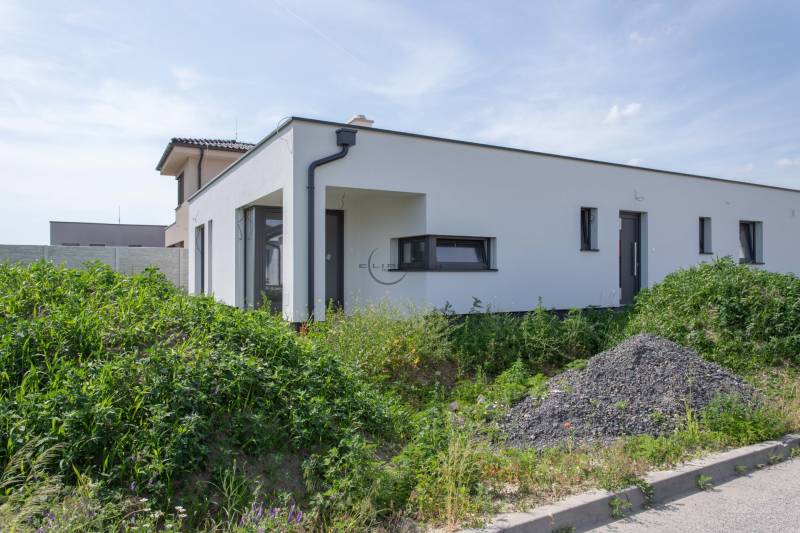 A family house in Zohor with a white facade and surrounding greenery.