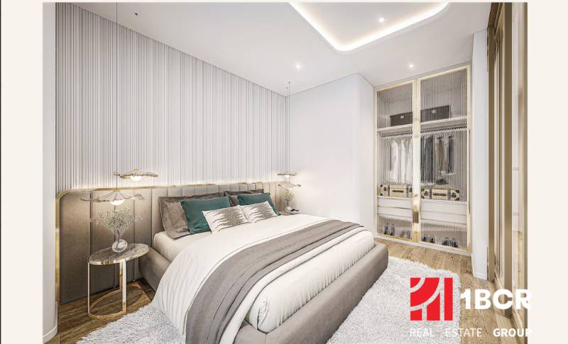 A bedroom in a 2-room apartment with a stylish bed and a built-in wardrobe.