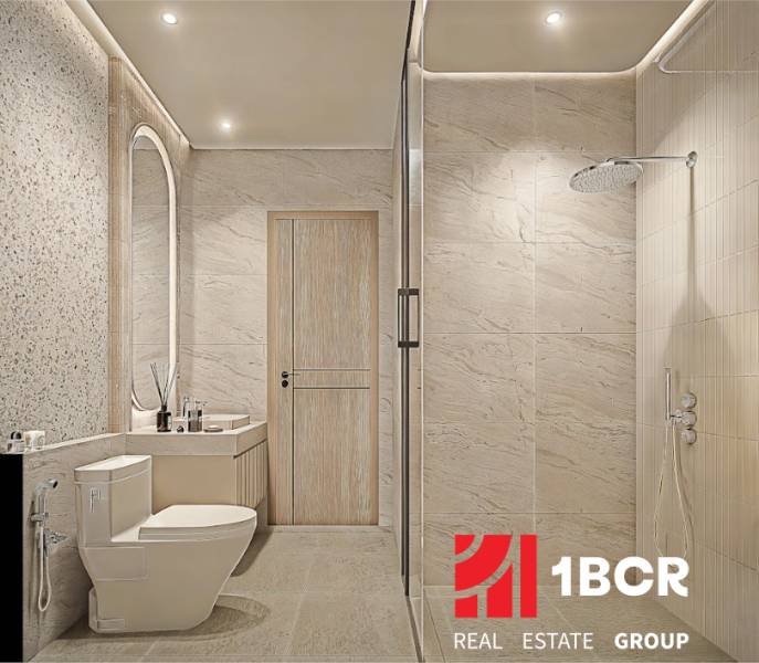 Bathroom in a 2-room apartment with sliding shower doors and an elegant sink.