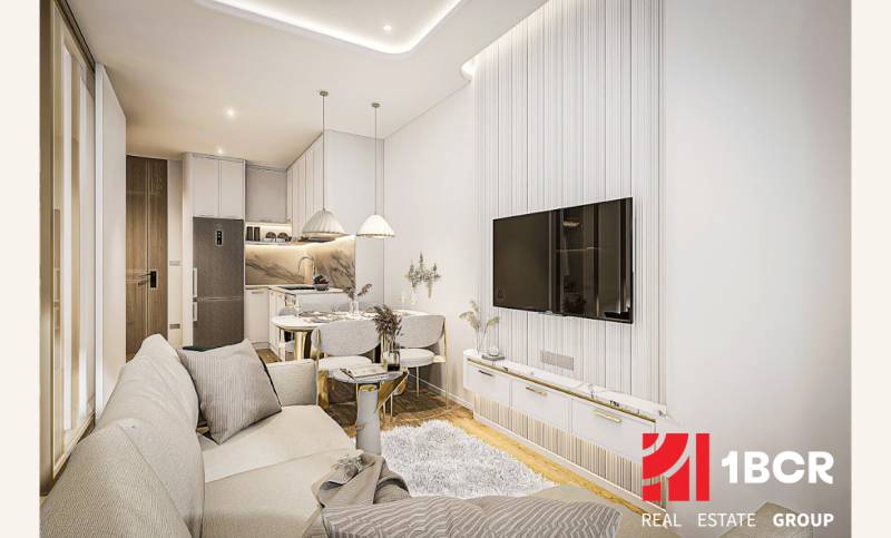 Living room with kitchen in a 2-room apartment, bright colors and comfortable seating.