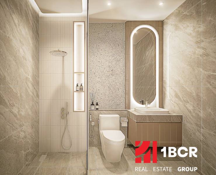 A bathroom of a three-room apartment with a minimalist design, a shower, and a backlit mirror.
