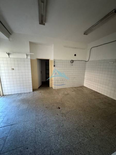 Commercial premises with tiled walls, empty room.