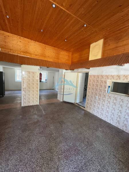 Wooden ceiling and tiled wall in commercial premises.
