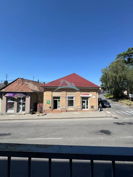 Commercial premises on the Main Square in Šahy with a red roof and blue sky.