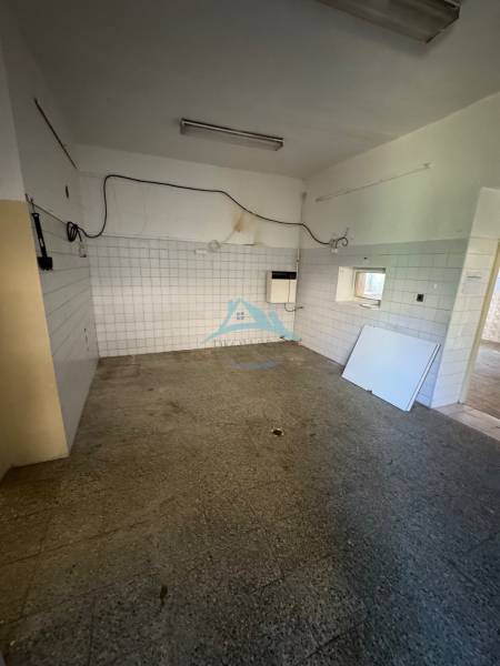An empty interior with tiles and a concrete floor in commercial premises.