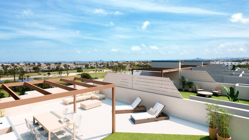 A terrace with a view of RODA, seating, loungers, and greenery in a 4-room apartment.