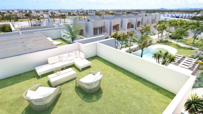 A terrace with a view of the pool, surrounded by greenery, belonging to a 4-room apartment in Rode.