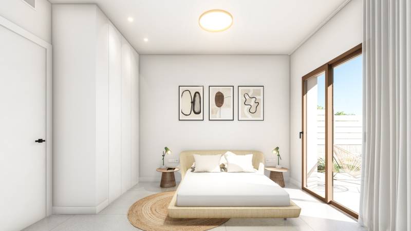 A bright bedroom in a 4-room apartment with a minimalist bed and access to the terrace.