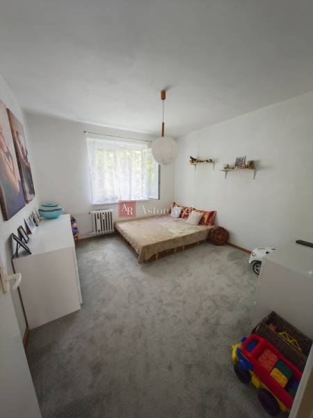 A children's room with a bed, wardrobe, and toys in a 2-room apartment.