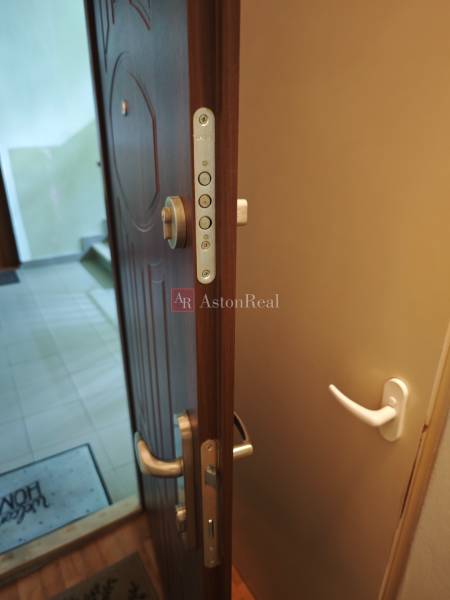 Open security door at the entrance to a 2-room apartment with a handle.