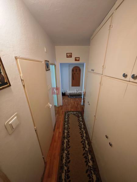 A hallway with a wooden floor and built-in wardrobes in a 2-room apartment.