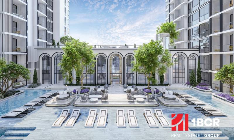 Apartment construction in Pattaya with a garden, swimming pool, and sun loungers.