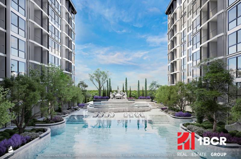 The construction of apartments in Pattaya includes a pool and gardens between the buildings.