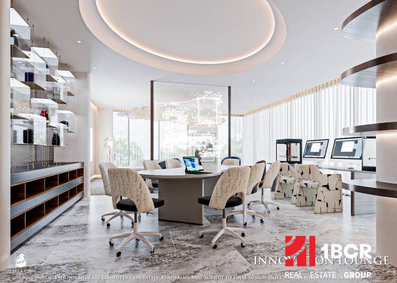 Interior of an office with a round table, computers, and modern lighting. Apartment construction.