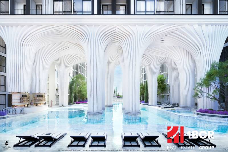 Luxury apartment development with a pool and white columns reminiscent of futuristic architecture.