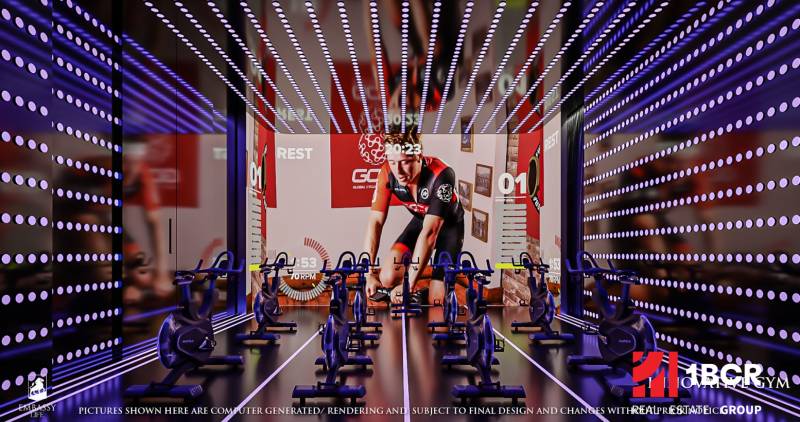 Fitness studio with exercise bikes and a projected screen under construction in an apartment building.