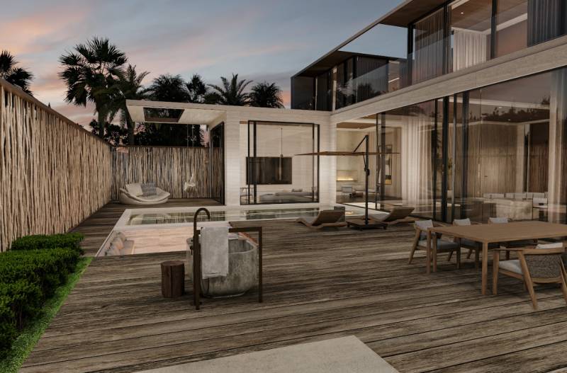 A family house with a spacious terrace and a swimming pool, surrounded by tropical plants.