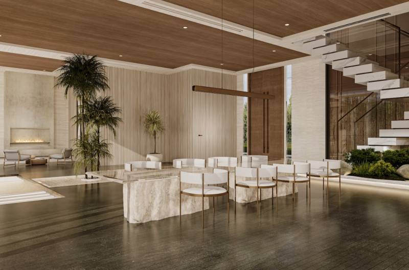 Luxury living room in a family house with a fireplace, staircase, and greenery.