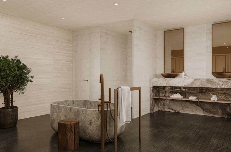 A family house bathroom with an oval stone bathtub and elegant sinks.