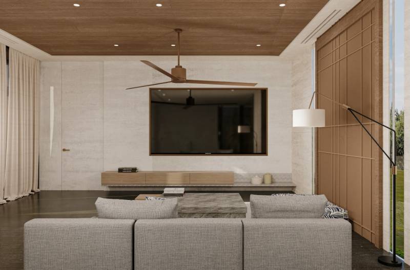 Living room in a family house with a comfortable sofa and a TV on the wall.