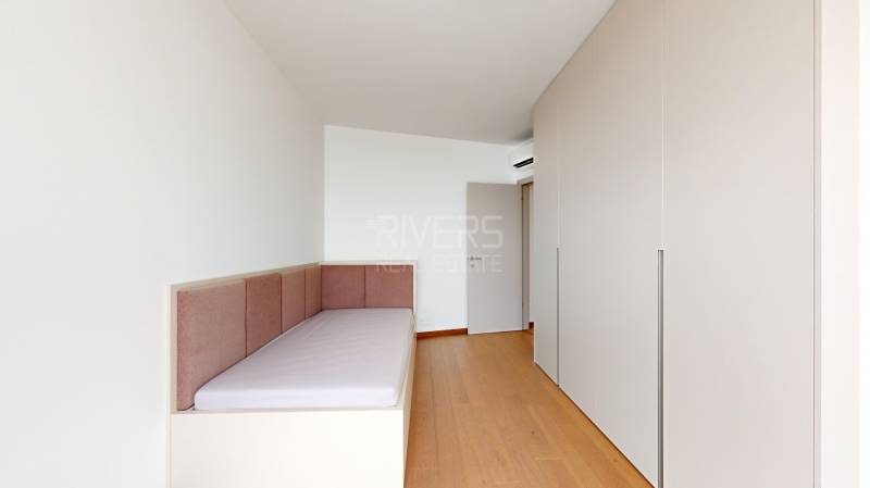 A room with a bed and a built-in wardrobe in a 4-room apartment.