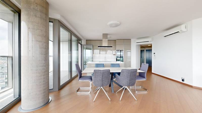 Stylish 4-room apartment with a dining table and panoramic windows.