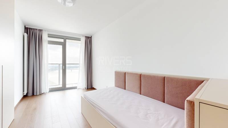 A bright room with a bed, white walls, and a window in a 4-room apartment.