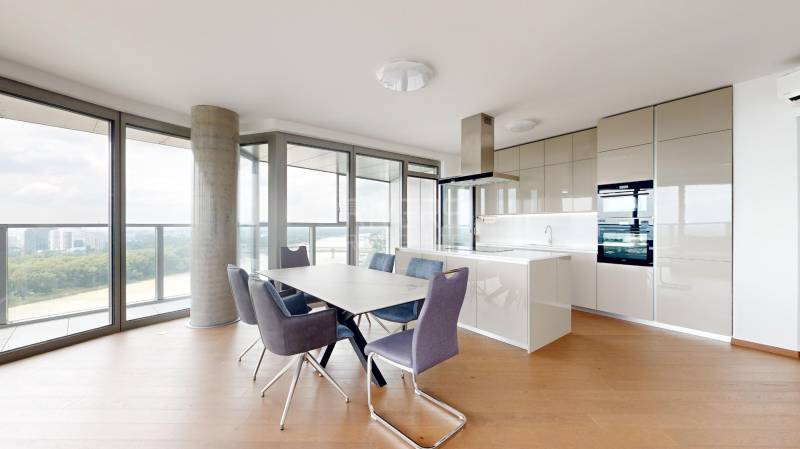 A kitchen in a 4-room apartment with a dining table and a panoramic view.