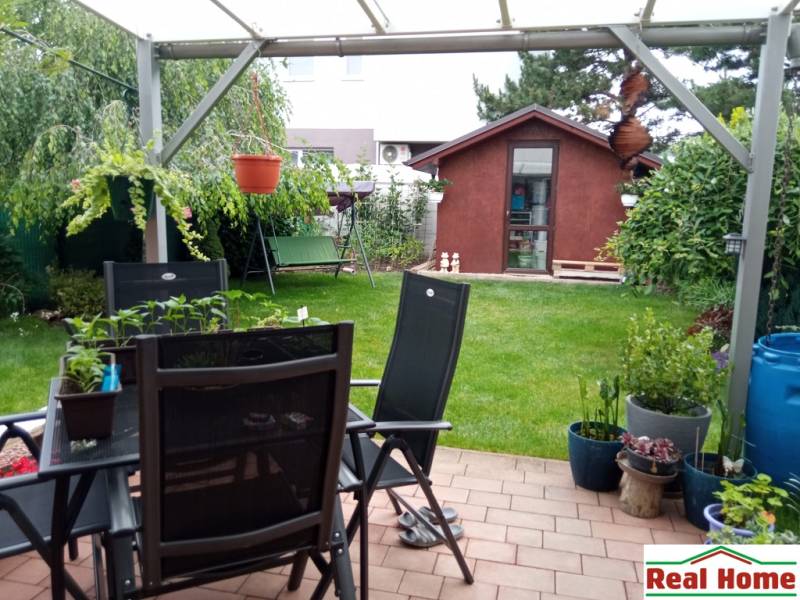 The garden of a family house on Brusnicova Street in Chorvátsky Grob with a terrace and a gazebo.