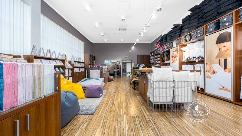 Retail space with shelves full of textiles and colorful bean bags.