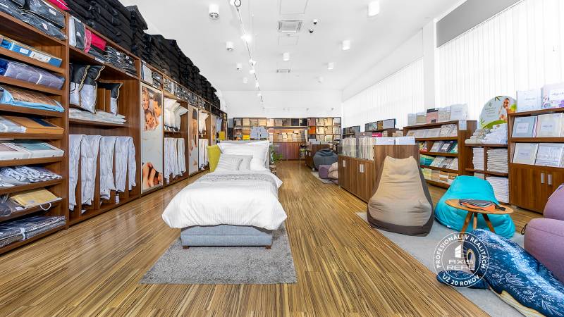 Bedding and pillows displayed in a retail space with wooden flooring.