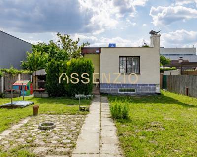 A family house on Mokráň Záhon in Bratislava - Ružinov with a well-maintained garden and trees.