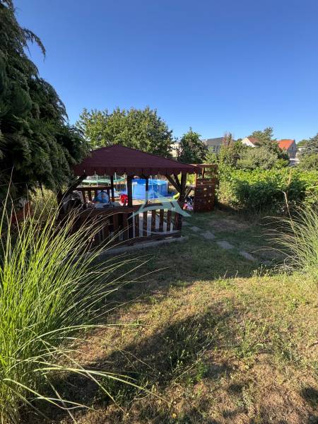 Summer terrace with a gazebo and a pool on Obrancov Mieru Street in Šahy by a 3-room apartment.