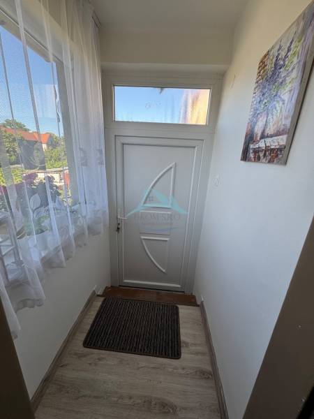 Entrance hallway in a 3-room apartment with white doors and a doormat.