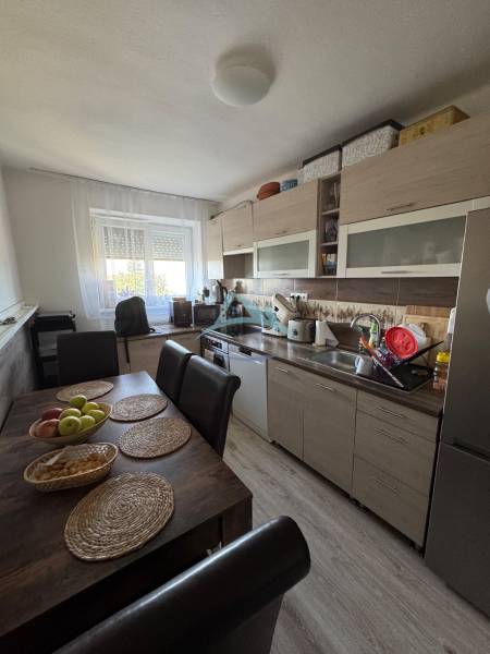 A kitchen in a 3-room apartment with a dining table and light furnishings.