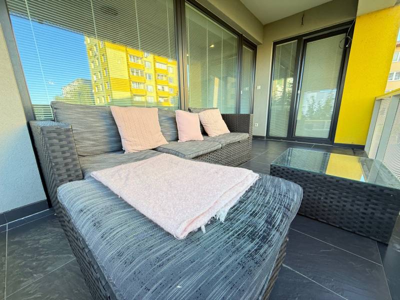 Terrace of a 4-room apartment in Topoľčany with seating, a glass table, and a sofa.