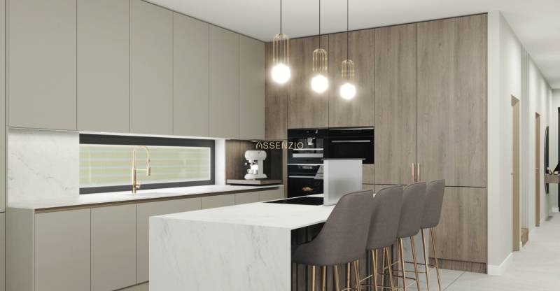 A kitchen in a family house with a white marble island and stylish lighting fixtures.