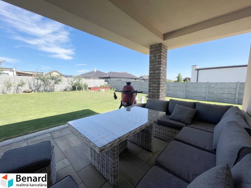 A family house in Prešov with a spacious covered terrace and garden seating.