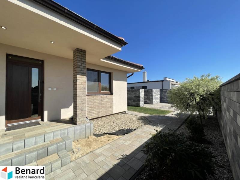 A family house in Prešov with a terrace, landscaped garden, and paved walkway.