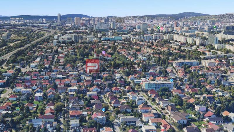 Aerial view of family houses in Bratislava, green area and city skyline.