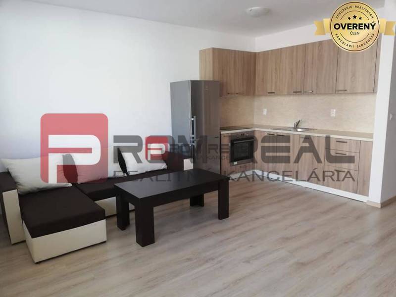 Living room on Slavomírova Street, 2-room apartment, kitchenette, sofa, table, wooden floor.