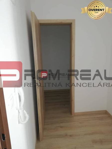 Opening wooden doors lead from a 2-room apartment on Slavomírova Street, with bright parquet floors.